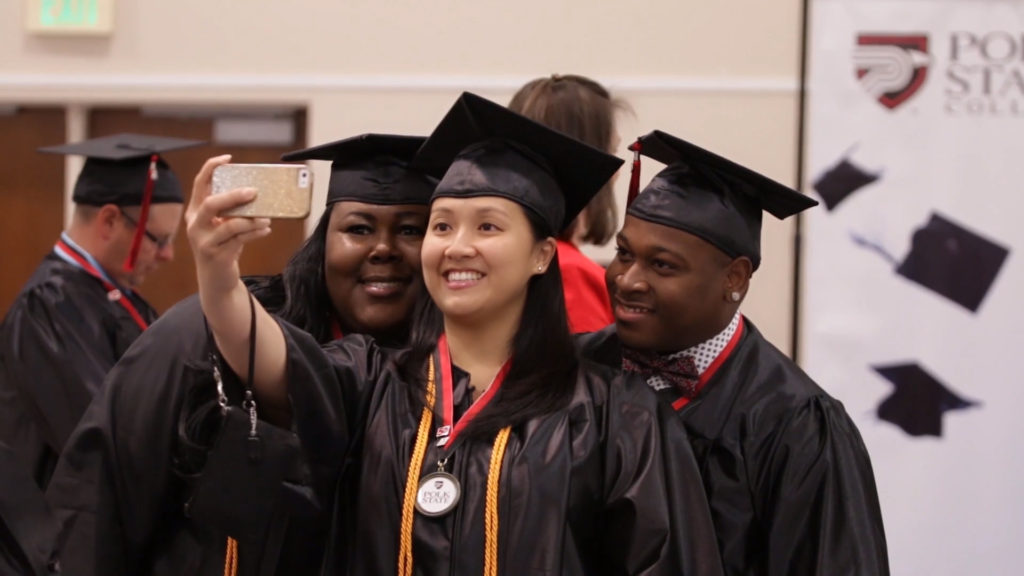 Group of 3 graduates taking a selfie